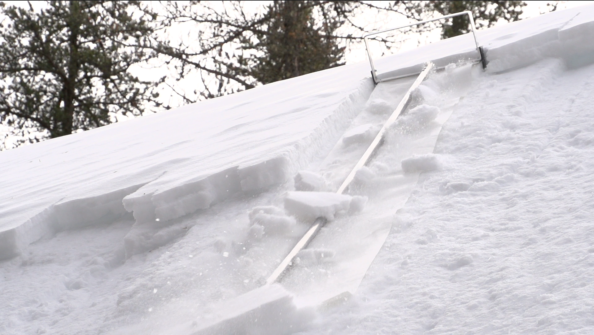 Snow accumulation on a roof with gutters during winter
