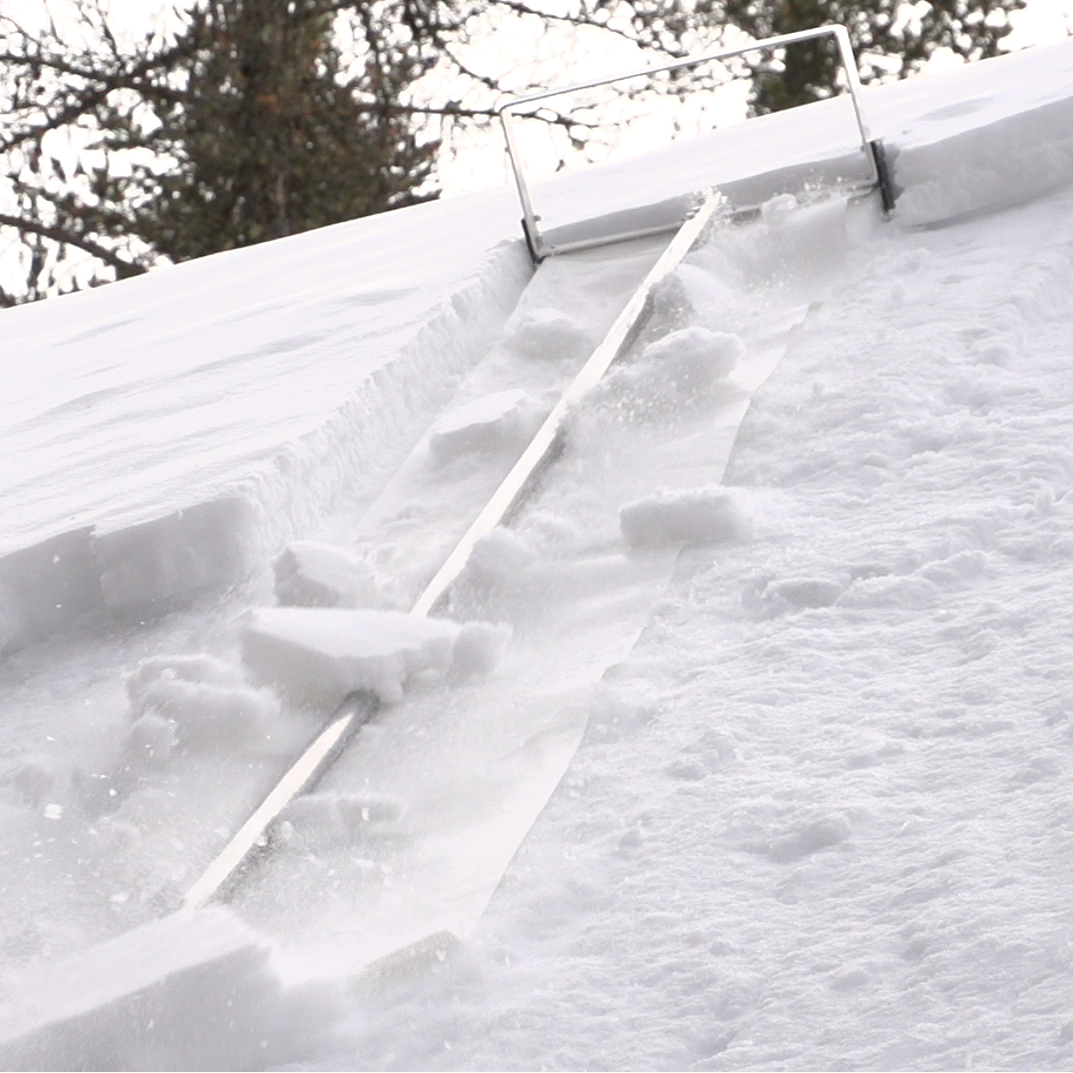 Snow accumulation on a roof with gutters during winter